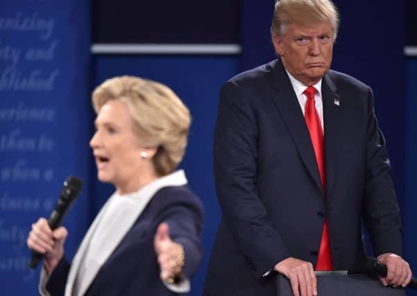 TOPSHOT - Republican presidential candidate Donald Trump listens to Democratic presidential candidate Hillary Clinton during the second presidential debate at Washington University in St. Louis, Missouri on October 9, 2016. / AFP PHOTO / Paul J. RichardsPAUL J. RICHARDS/AFP/Getty Images