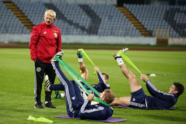 Scotland manager Gordon Strachan watches James McArthur, Barry Bannan and John McGinn stretch at last nights training session at the Stadion Pasienky, Bratislava, as they prepare to face Slovakia. Picture: Nick Potts/PA Wire.