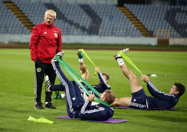 Scotland manager Gordon Strachan watches James McArthur, Barry Bannan and John McGinn stretch at last nights training session at the Stadion Pasienky, Bratislava, as they prepare to face Slovakia. Picture: Nick Potts/PA Wire.