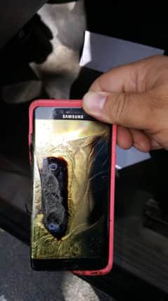 A customer shows his daughters Galaxy Note7 which had melted in her hand. Picture: AP