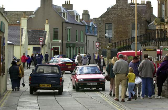 Pedestrians and traffic in Victoria Street, Stromness. Drivers on Orkney have faced steep rises in the cost of car insurance. Picture: Allan Milligan/TSPL