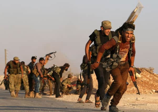 Fighters from opposition group the Free Syrian Army battle against IS in northern. Picture: AFP/Getty Images