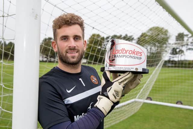 Dundee United's Cammy Bell with the Ladbrokes Championship Player of the Month Award for September. Picture: Kenny Smith/SNS