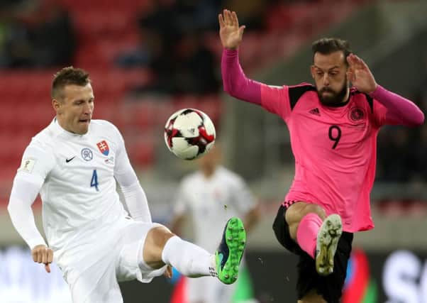 Scotland striker Steven Fletcher, right, and Slovakia's Jan Durica battle for the ball. Picture: Nick Potts/PA Wire.