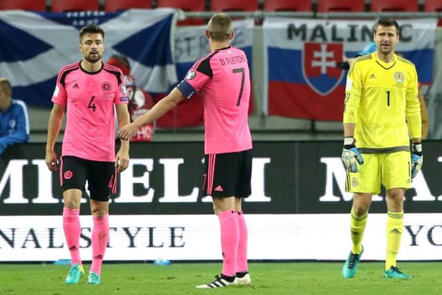 Scotland captain Darren Fletcher, centre, goalkeeper David Marshall, right, and defender Russell Martin look dejected during the defeat by Slovakia in Trnava. Picture: Nick Potts/PA Wire