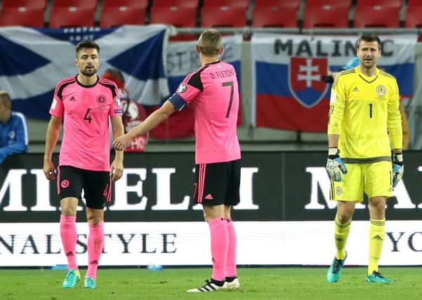 Scotland captain Darren Fletcher, centre, goalkeeper David Marshall, right, and defender Russell Martin look dejected during the defeat by Slovakia in Trnava. Picture: Nick Potts/PA Wire