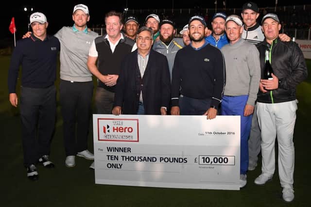 Alexander Levy receives his winner's cheque after coming out on top in the inaugural Hero Challenge at The Grove. Picture: Getty Images