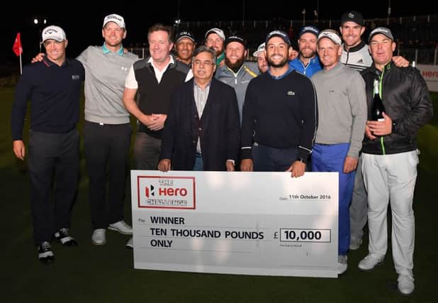 Alexander Levy receives his winner's cheque after coming out on top in the inaugural Hero Challenge at The Grove. Picture: Getty Images