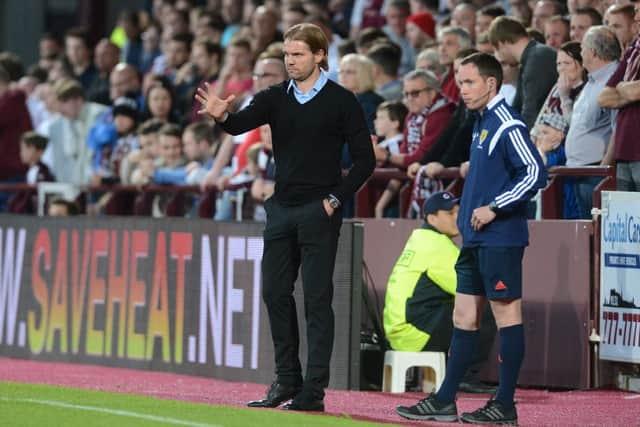 Hearts boss Robbie Neilson in front of the current main stand at Tynecastle. Picture: Neil Hanna