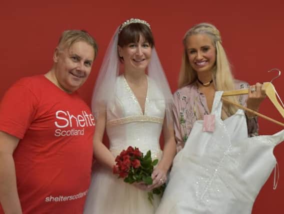 Carolyn Smart, a money and debt advisor at the Shelter Scotland Dundee Hub, models one of the dresses, alongside Shelter colleague John Sinclair and Anne Elder, owner of Annarose Bridal.