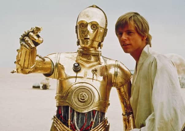 Mark Hamill  portrays the character Luke Skywalker in this scene from the initial "Star Wars" release, with the droll droid C-3PO.
Photo:  Lucasfilm Ltd. & TM. All rights reserved.)