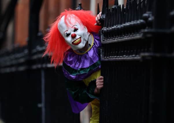 The 'killer clown' involves pranksters dressing up as clowns and frightening passersby. Picture: Peter Byrne/PA Wire