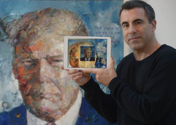 Trevor Jones shows off the app with his Donald Trump portrait. Photograph: Neil Hanna