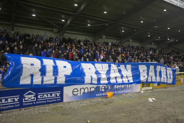 Rangers fans hold a banner in memory of Ryan Baird. Picture: Jeff Holmes/PA Wire