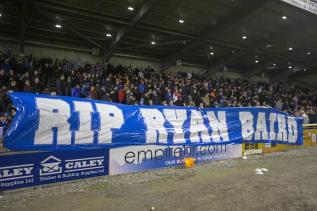 Rangers fans hold a banner in memory of Ryan Baird. Picture: Jeff Holmes/PA Wire