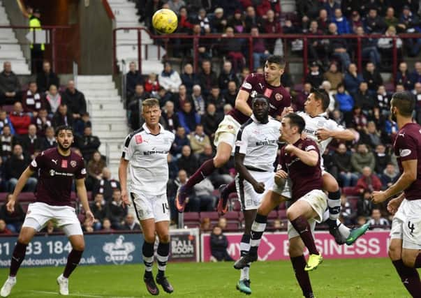 Callum Paterson's towering header gave Hearts the lead in the second half. Picture: SNS