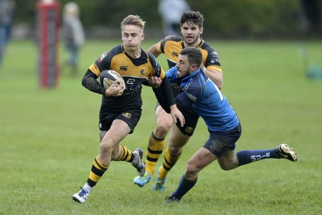Harvey Elms of Currie is tackled by Chris Laidlaw of Boroughmuir. Picture:
Neil Hanna