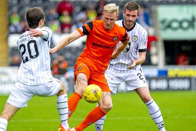 Dundee United's Nick van der Velden holds off St Mirren's Jason Naismith. Picture: SNS