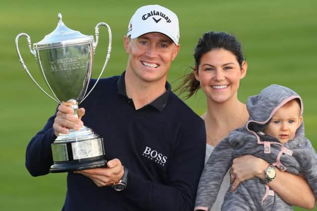 Alex Noren with, his girlfriend Jennifer Kovacs and their daughter Iris pose with the trophy following his victoryin the British Masters. Picture: Andrew Redington/Getty Images