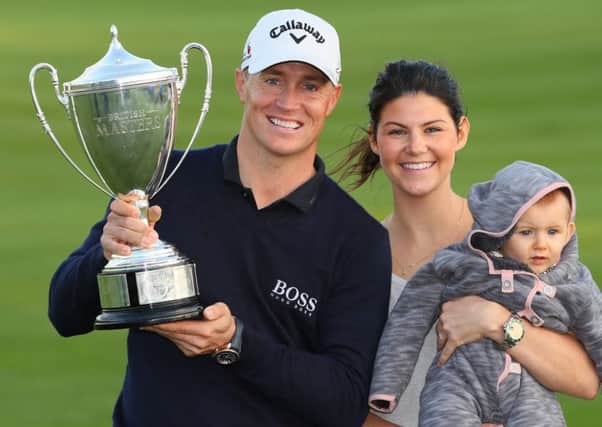 Alex Noren  with, his girlfriend Jennifer Kovacs and their daughter Iris pose with the trophy following his victoryin the British Masters. Picture:  Andrew Redington/Getty Images