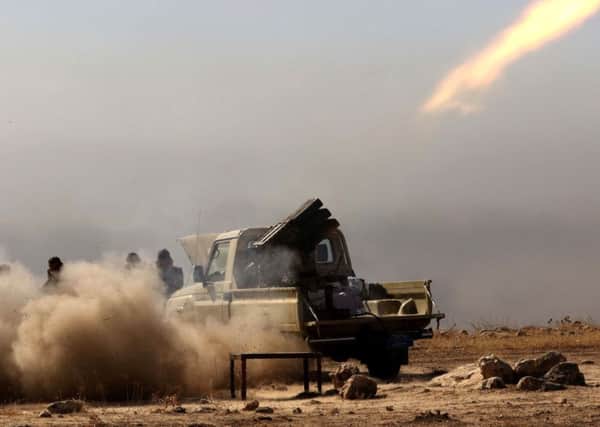 Iraqi Kurdish Peshmerga fighters fire a multiple rocket launcher east of Mosul as part of a broad operation to retake the city from Islamic State. Picture: Getty Images