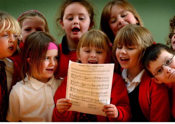Children at Bunsgoil Ghaidhlig Ghlaschu (Glasgow Gaelic School) put the finishing touches to one of their musical entries for the Mod in 2003