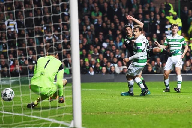 Borussia Monchengladbach's Lars Stindl squeezes the ball through the legs of Celtic stopper Craig Gordon. Picture: SNS