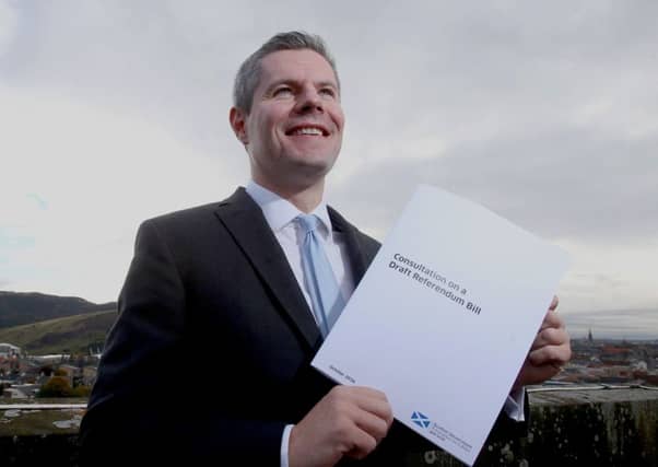 Constitution Minister Derek Mackay holds a copy of the Consultation on a Draft Referendum Bill published by the Scottish Government as a precursor to a possible indyref2. Picture PA