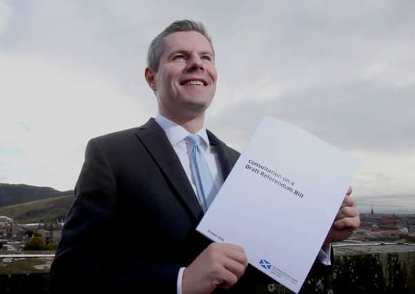 Constitution Minister Derek Mackay holds a copy of the Consultation on a Draft Referendum Bill published by the Scottish Government as a precursor to a possible indyref2. Picture PA