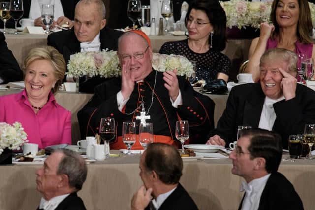 Democratic presidential nominee Hillary Clinton, Timothy Cardinal Dolan, Archbishop of New York, and Republican presidential nominee Donald Trump at the Alfred E. Smith Memorial Foundation Dinner  AFP PHOTO / Brendan Smialowski/Getty Images