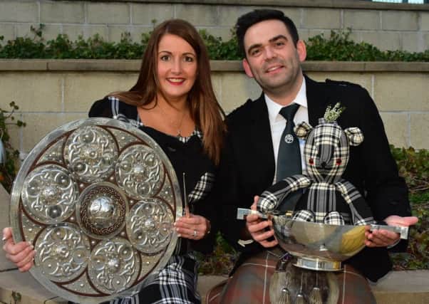 Dingwall Gaelic Choir enjoyed a clean sweep of trophies at the Mod. Conductor Kirsteen Menzies holds the Lovat & Tullibardine Shield, and Steven MacIver holds the Weekly Scotsman Quaich - plus mascot.