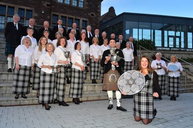 The full Dingwall Gaelic Choir, with the Lovat and Tullibardine Shield and the Weekly Scotsman Quaich.