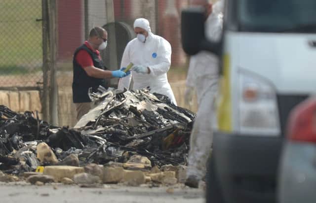 Forensics experts sift through debris at Maltas main airport after a plane carrying French officials crashed shortly after take-off. Picture: AFP/Getty Images