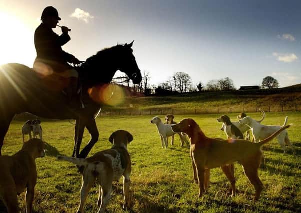Trevor Adams Master of the Buccleuch hunt takes calls his hounds to start the hunt Photo: David Cheskin/PA