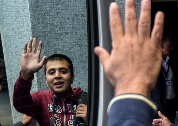 Harris Ghazi waves to his uncle as he leaves a visa office in East Croydon. Harris is one of the refugee children who arrived in Britain from the Jungle. Picture: SWNS