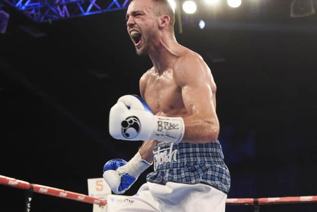 Josh Taylor celebrates lifting the Commonwealth belt after beating Dave Ryan. Photograph: Ian Rutherford
