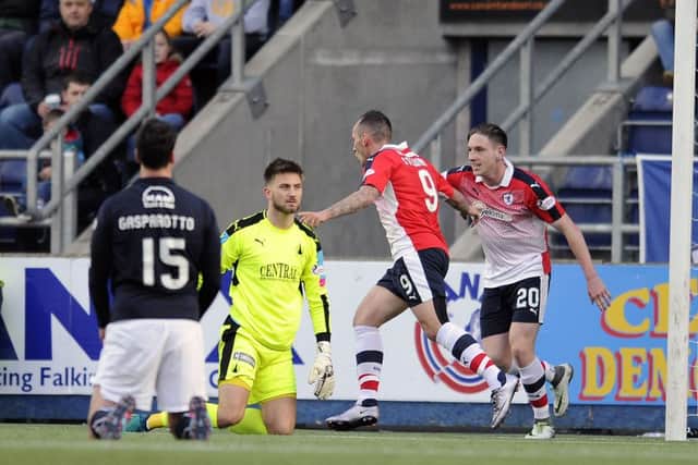 Mark Stewart, wearing No 9, has the Falkirk defence on its knees after scoring Raiths second goal. Picture: Michael Gillen