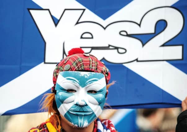 An independence campaigner outside last weekend's SNP conference. Picture: John Devlin