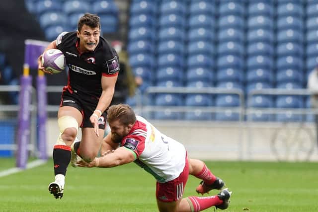 Edinburgh's Damien Hoyland, left, evades the diving Rob Buchanan during the home side's narrow win over Harlequins at BT Murrayfield. Picture: SNS Group