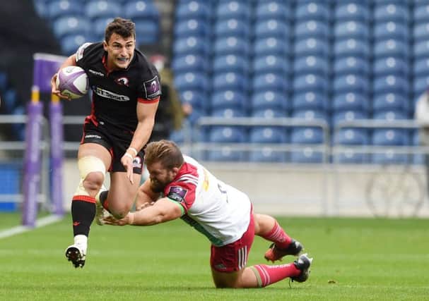 Edinburgh's Damien Hoyland, left, evades the diving Rob Buchanan during the home side's narrow win over Harlequins at BT Murrayfield. Picture: SNS Group