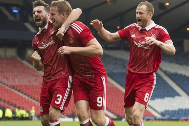 Adam Rooney, centre, celebrates having given Aberdeen the lead over Morton. Picture: SNS.