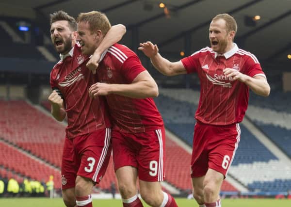 Adam Rooney, centre, celebrates having given Aberdeen the lead over Morton. Picture: SNS.