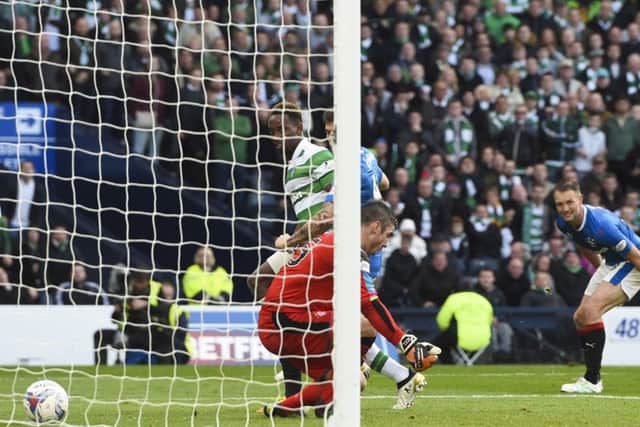 Moussa Dembele (left) watches on as his flick evades Matt Gilks, giving his side the victory. Picture: SNS