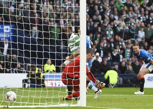 Moussa Dembele (left) watches on as his flick evades Matt Gilks, giving his side the victory. Picture: SNS