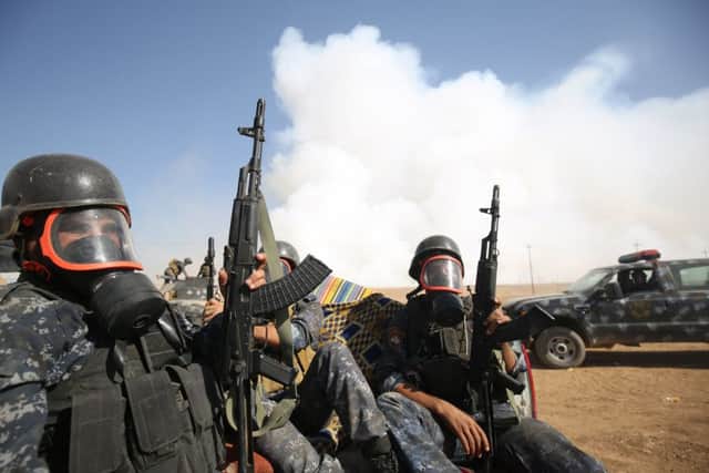 Iraqi forces wear gas masks for protection after IS jihadists torched Mishraq sulphur factory, near the Qayyarah base, about 30 kilometres south of Mosul. Picture: Getty