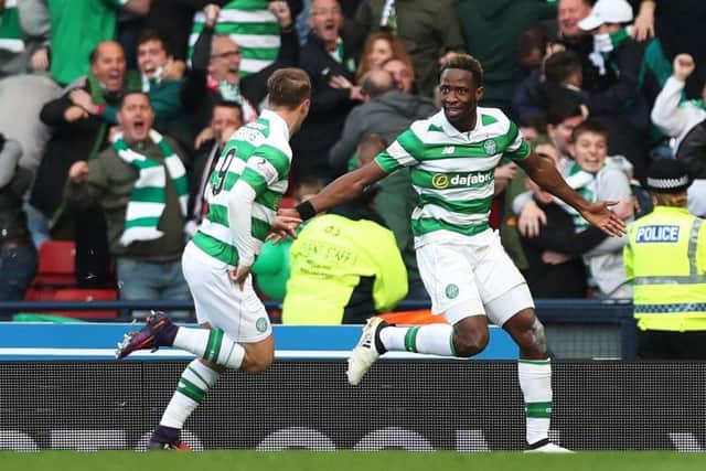 Goal hero Moussa Dembele turns to his provider, Leigh Griffiths, as the pair celebrate Celtic's League Cup semi-final win over Rangers. Picture: Getty Images
