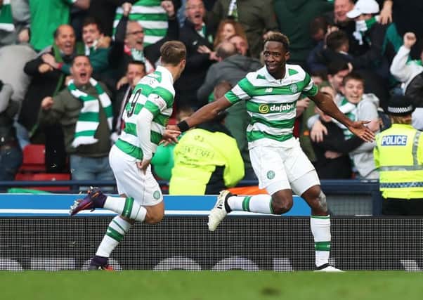 Goal hero Moussa Dembele turns to his provider, Leigh Griffiths, as the pair celebrate Celtic's League Cup semi-final win over Rangers. Picture: Getty Images