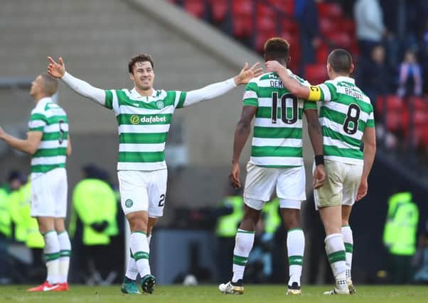 Erik Sviatchenko, left, celebrates at full-time with Moussa Dembele and Scott Brown, right. Picture: Getty