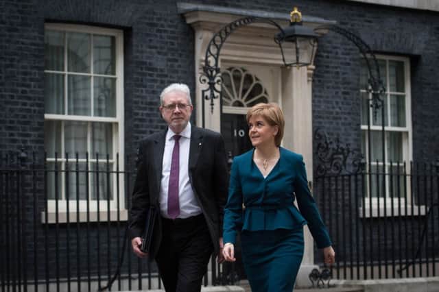 Nicola Sturgeon leaves Downing Street with her Brexit minister Michael Russell after meeting Theresa May. Picture: PA