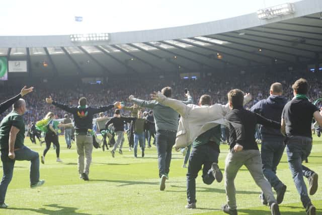 Hibs supporters invade the pitch at full-time. Picture: Greg Macvean